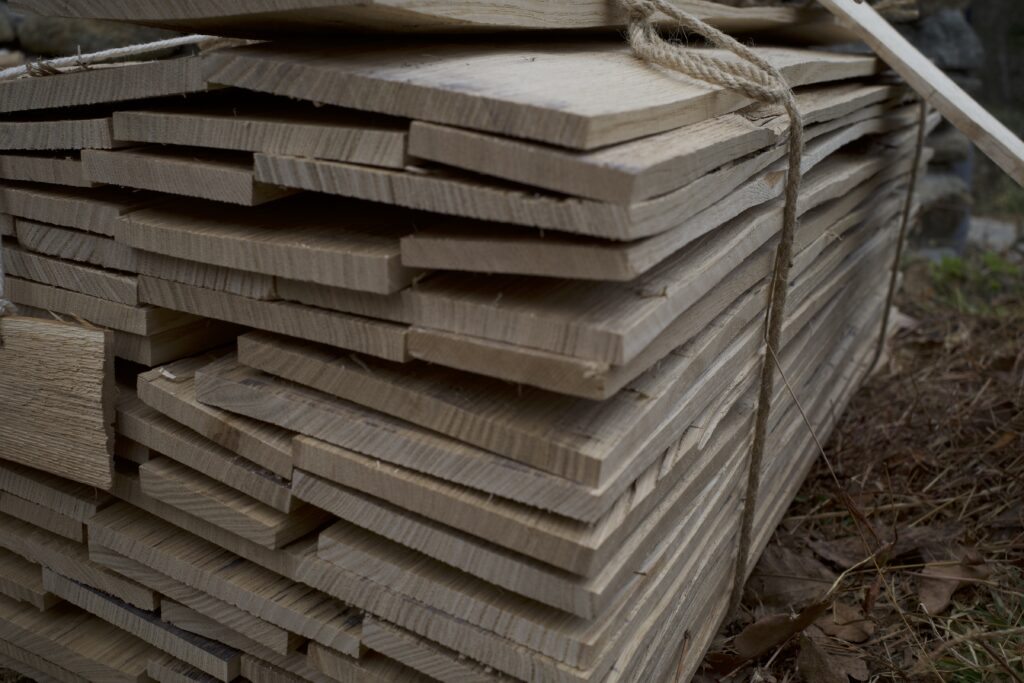 Stacked traditional Japanese KURE roof boards made by splitting logs